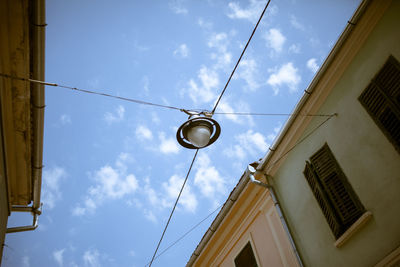 Low angle view of street light against building