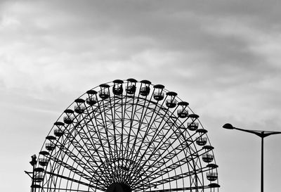 Low angle view of ferris wheel against sky