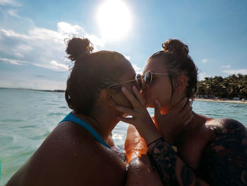 Side view of couple kissing in sea