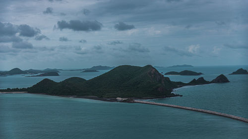 Scenic view of sea and mountains against sky