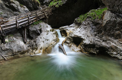 Scenic view of waterfall along trees