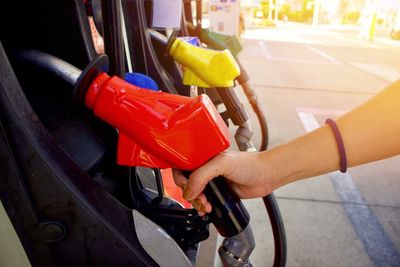 Close-up of hand holding red car