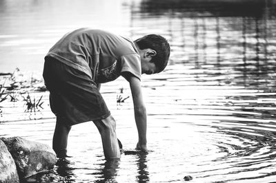 Side view of boy standing in water