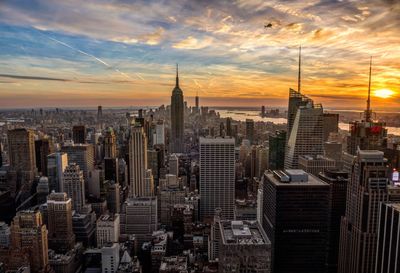 High angle view of empire state building in city against sky during sunset