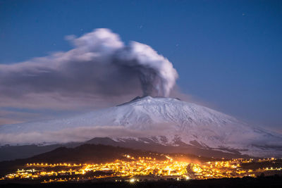 Scenic view of smoke emitting from volcanic crater during winter