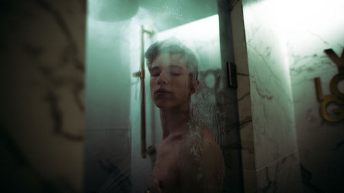 Shirtless man in bathroom at home