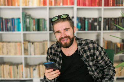 Portrait of smiling young man using mobile phone