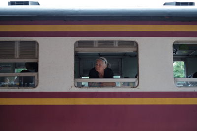 Portrait of woman looking through train window