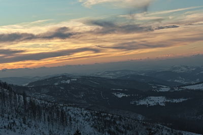 Scenic view of snowcapped mountains against sky during sunset