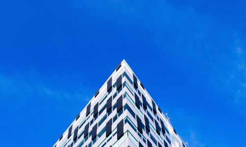 Low angle view of building against blue sky