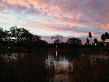 Scenic view of lake against sky at sunset