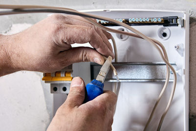 Cropped hand of man repairing car