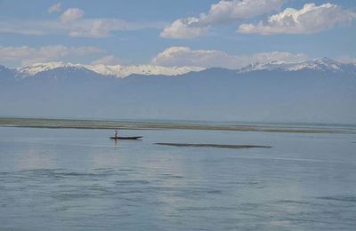 Scenic view of lake and mountains against sky