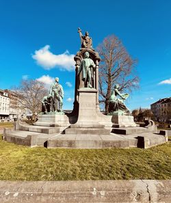 Low angle view of statue against blue sky