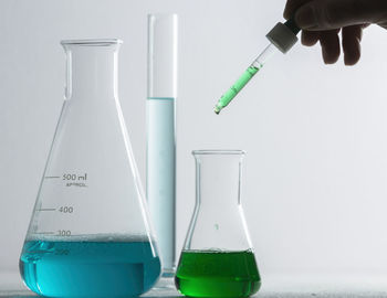 Midsection of man with text on glass against white background