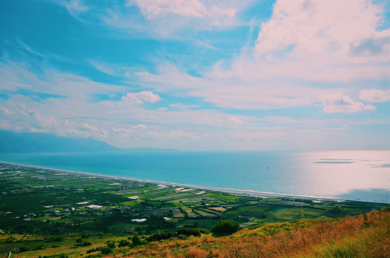 sea, water, tranquil scene, sky, scenics, horizon over water, tranquility, beauty in nature, nature, blue, high angle view, cloud - sky, idyllic, landscape, coastline, cloud, outdoors, mountain, no people, beach