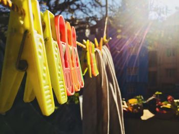 Close-up of multi colored umbrellas hanging on street in city