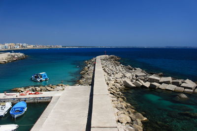 Scenic view of sea against clear blue sky