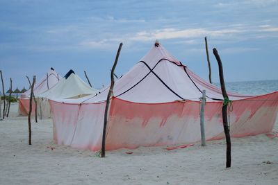 Umbrellas on beach against sky