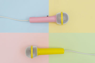Directly above shot of microphones on colored background