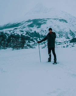 Man standing on snow covered land