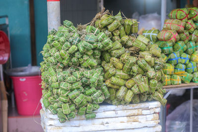 Vietnamese fermented pork roll and cylindrical sticky rice cake are displayed on the street