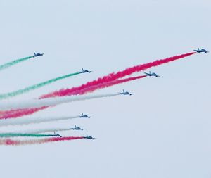 Low angle view of airshow against clear sky