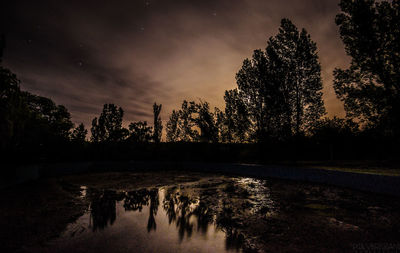 Scenic view of lake against sky at sunset