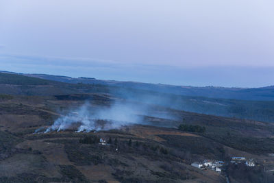 Aerial view of smoke emitting over land