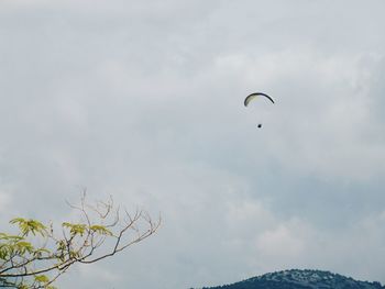 Low angle view of paragliding against sky