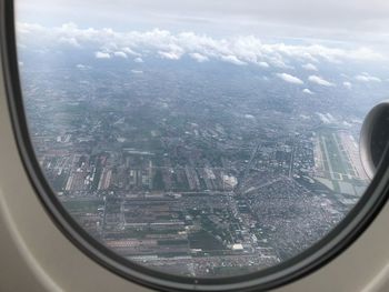 Aerial view of cityscape seen through airplane window