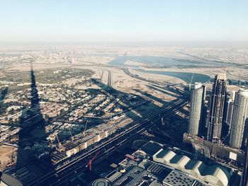 High angle view of buildings by river against sky