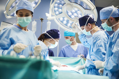 Doctors operating patient in emergency room