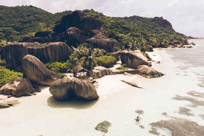 Rocks on beach against sky