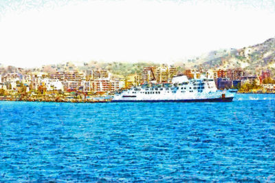 Boats in sea by cityscape against clear sky