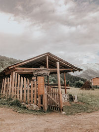 Abandoned house on field against sky