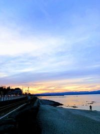 Scenic view of beach against sky during sunset