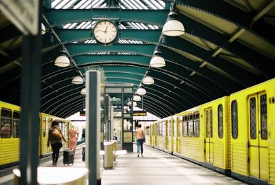 Passengers walking in railroad station