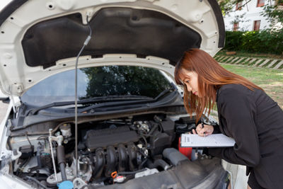 High angle view of woman on car windshield