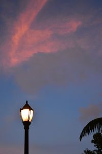 Low angle view of illuminated street light against sky at sunset