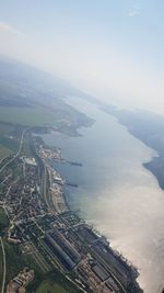 High angle view of river amidst cityscape against sky