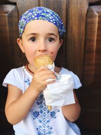 Close-up portrait of cute girl eating food