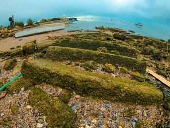 High angle view of rocks by sea against sky