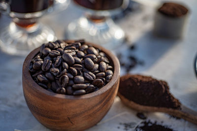 Still life with coffee beans, ground coffee, coffee grinder, wooden spoon, coffee pot, scoop