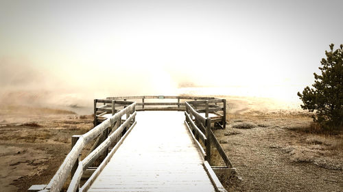Metallic structure on field against clear sky
