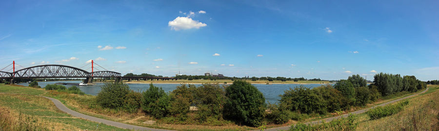 Panoramic view of bridge over river against sky