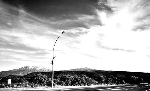 Street by mountain against sky