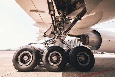 Close-up of airplane against cloudy sky