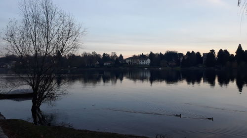 Scenic view of lake against sky at sunset