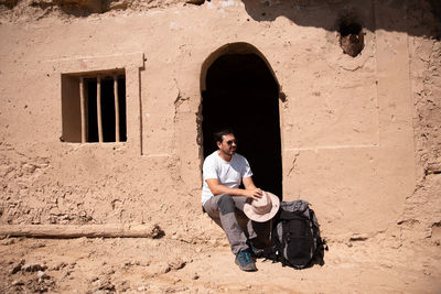 Full length of a man sitting outdoors